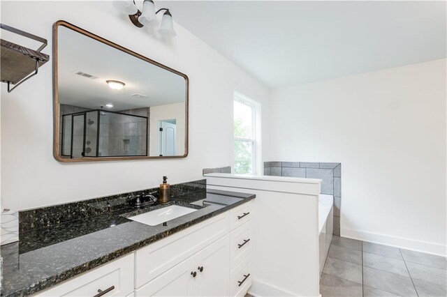 bathroom featuring shower with separate bathtub, tile patterned flooring, and vanity