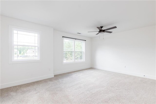 unfurnished room with ceiling fan and carpet flooring