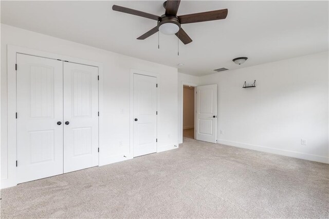 unfurnished bedroom with ceiling fan and carpet floors