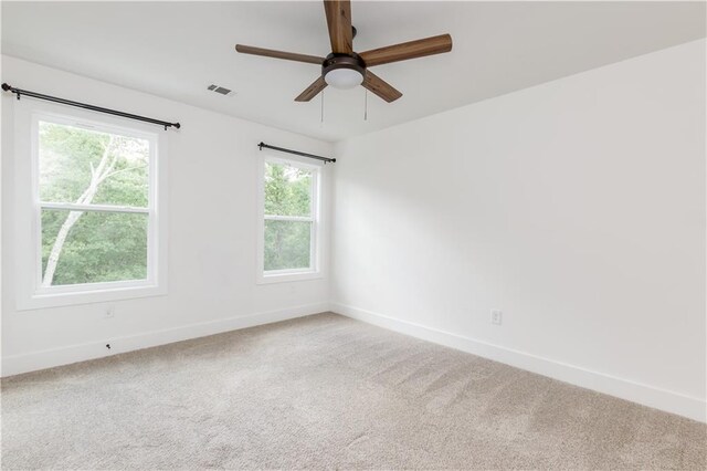 unfurnished room with carpet and ceiling fan