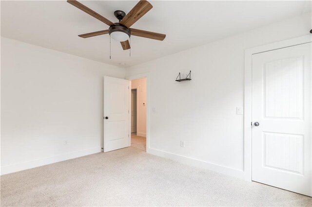 interior space featuring light carpet and ceiling fan