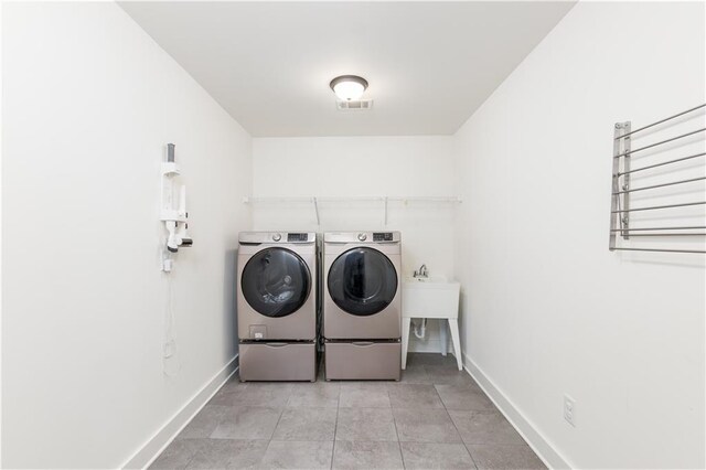 laundry room featuring washing machine and clothes dryer