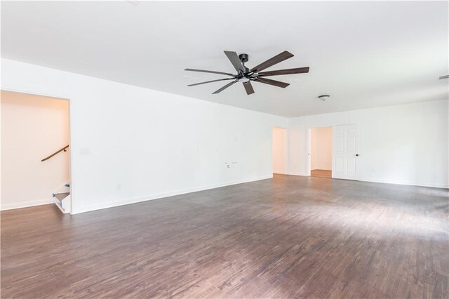 spare room with dark hardwood / wood-style floors and ceiling fan