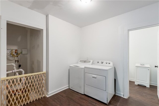 laundry room with dark hardwood / wood-style flooring and independent washer and dryer