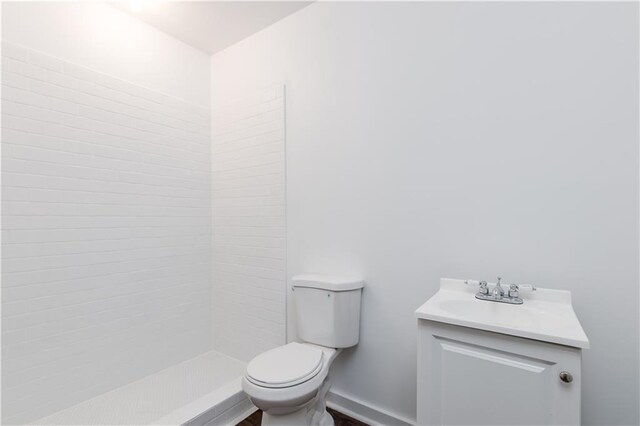 bathroom with a shower, vanity, and toilet