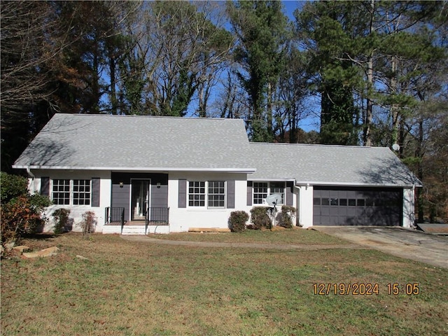 ranch-style home with a front lawn and a garage