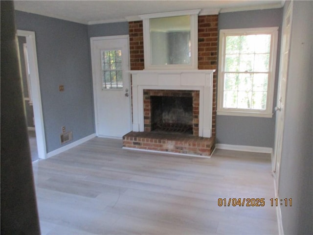 unfurnished living room with a fireplace and light wood-type flooring