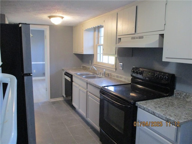 kitchen featuring white cabinetry, sink, a textured ceiling, light tile patterned floors, and black appliances