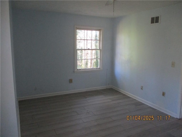 unfurnished room with dark wood-type flooring