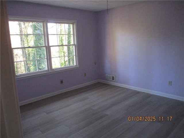 spare room with hardwood / wood-style flooring