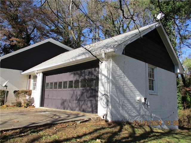 view of side of home featuring a garage