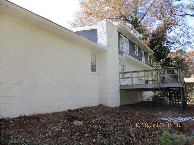 view of side of home with a deck