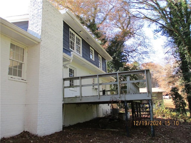 rear view of property featuring a deck