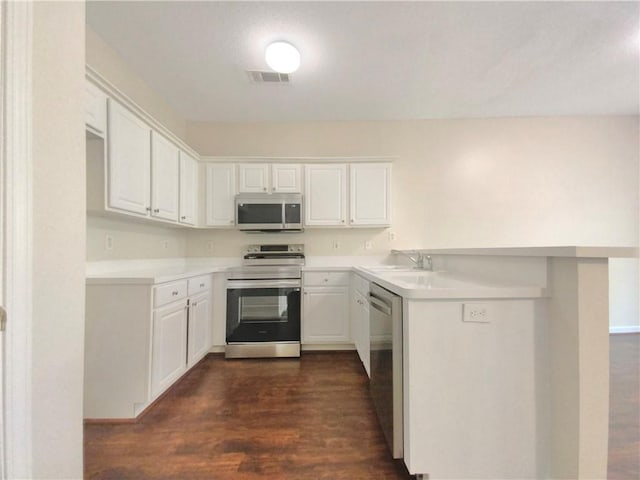 kitchen featuring white cabinetry, stainless steel appliances, dark hardwood / wood-style floors, and sink