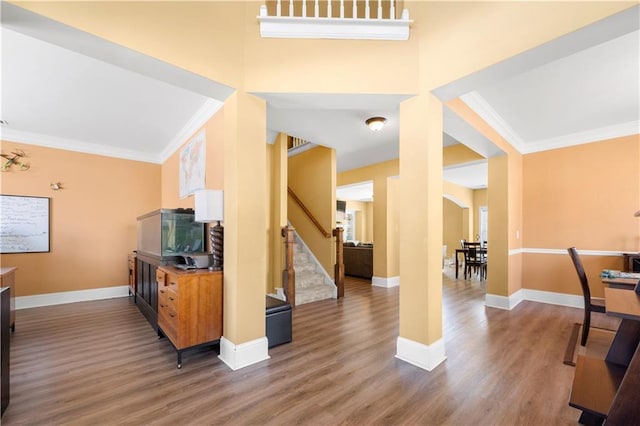 living room featuring ornamental molding, stairway, baseboards, and wood finished floors