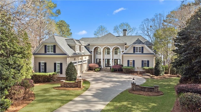 1070 Prosperity Pt, Greensboro, GA 30642 - view of front of house featuring driveway, a front lawn, stucco siding, and a chimney