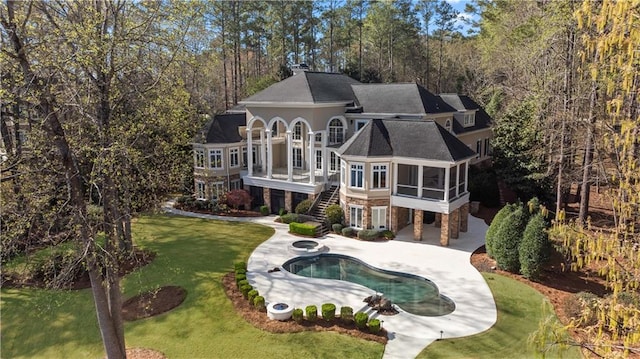 1070 Prosperity Pt, Greensboro, GA 30642 - rear view of property featuring a sunroom, stairs, a patio area, a lawn, and stone siding