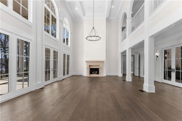 1070 Prosperity Pt, Greensboro, GA 30642 - unfurnished living room with a high ceiling, dark wood-style flooring, baseboards, a chandelier, and a fireplace