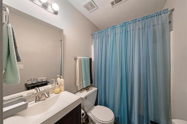 bathroom with vanity, a shower with shower curtain, a textured ceiling, and toilet