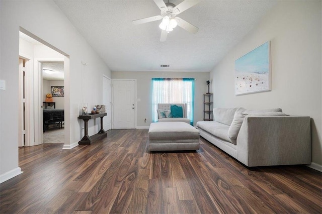 unfurnished living room featuring dark hardwood / wood-style flooring, ceiling fan, and a textured ceiling