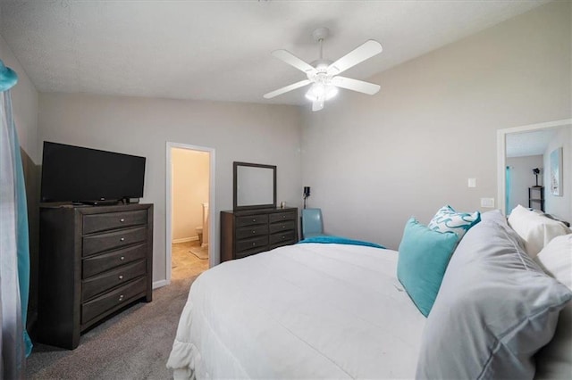 bedroom featuring ensuite bath, carpet floors, ceiling fan, and vaulted ceiling