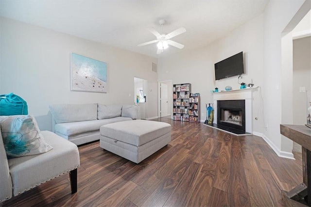 living room featuring ceiling fan and dark hardwood / wood-style floors