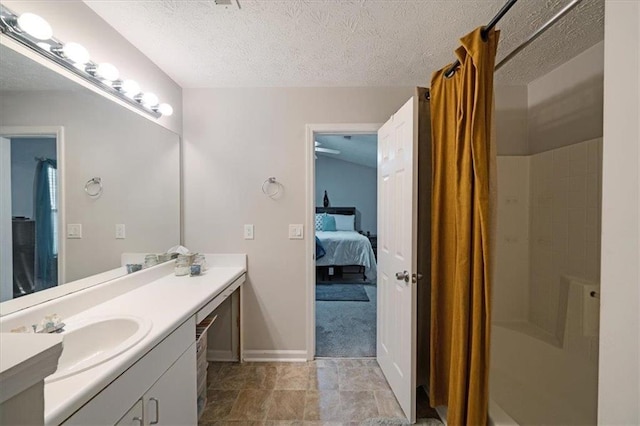 bathroom featuring vanity, a textured ceiling, and walk in shower