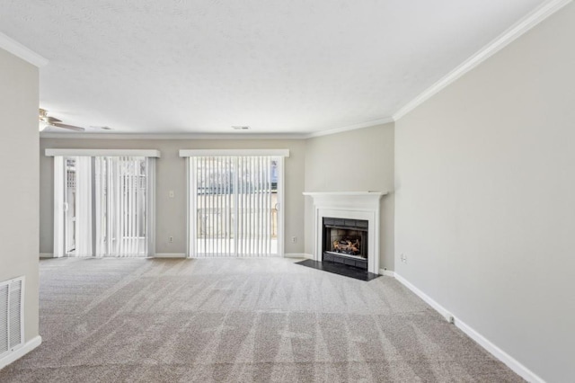 unfurnished living room with a fireplace with flush hearth, carpet, ornamental molding, and baseboards