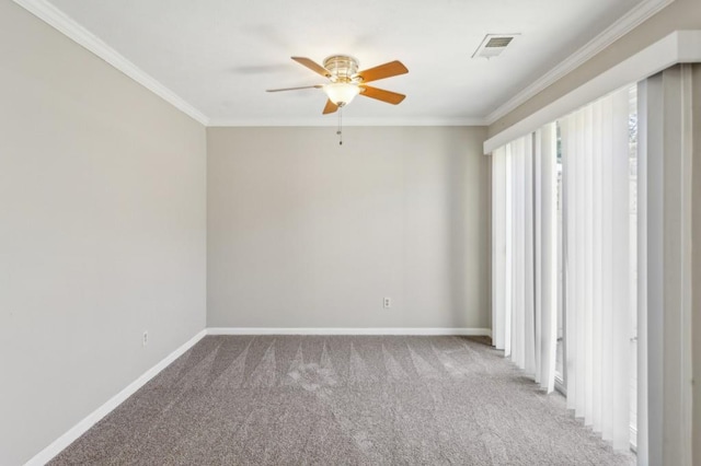 empty room featuring ornamental molding, visible vents, carpet floors, and baseboards