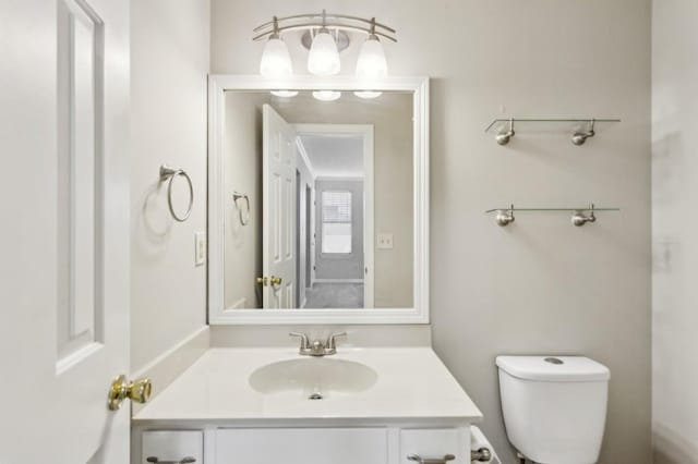 bathroom featuring toilet and vanity