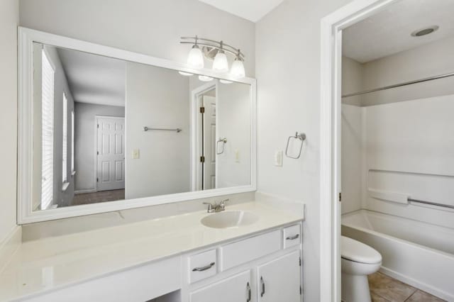 full bathroom featuring shower / bath combination, vanity, toilet, and tile patterned floors