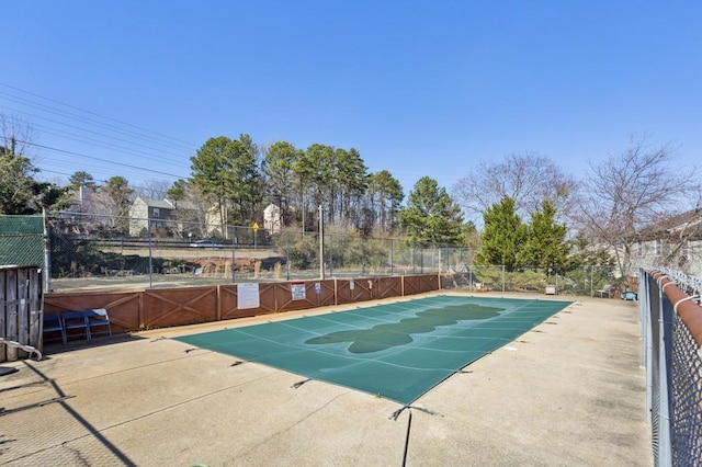 view of pool featuring fence and a patio