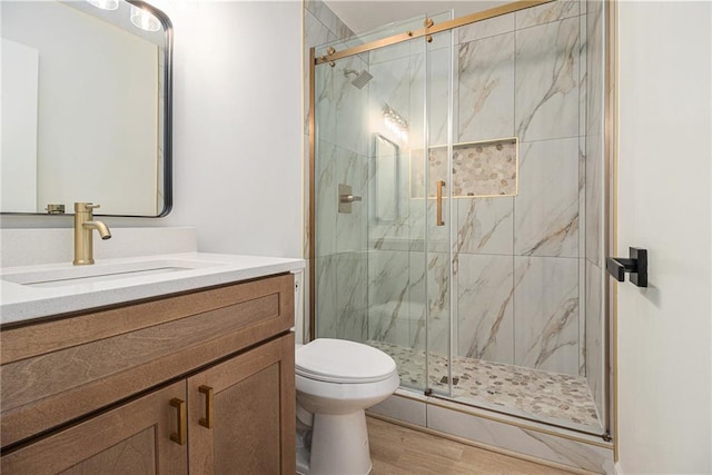 657 Stratford Green Way, Avondale Estates, GA 30002 - bathroom featuring toilet, vanity, a marble finish shower, and wood finished floors