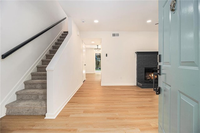 657 Stratford Green Way, Avondale Estates, GA 30002 - entrance foyer with stairway, light wood-type flooring, a brick fireplace, recessed lighting, and baseboards