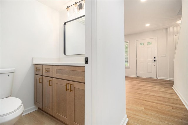 657 Stratford Green Way, Avondale Estates, GA 30002 - bathroom featuring toilet, vanity, wood finished floors, baseboards, and recessed lighting