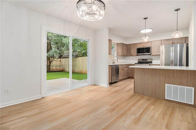 657 Stratford Green Way, Avondale Estates, GA 30002 - kitchen featuring stainless steel appliances, light countertops, a sink, and light wood finished floors
