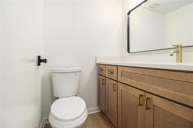 657 Stratford Green Way, Avondale Estates, GA 30002 - bathroom featuring baseboards, vanity, toilet, and wood finished floors