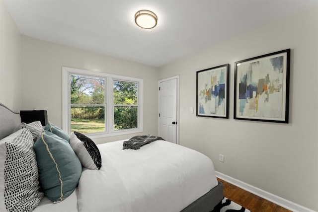 bedroom with dark hardwood / wood-style flooring