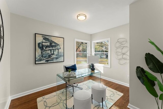 home office with dark hardwood / wood-style flooring