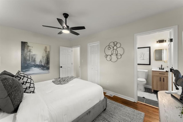 bedroom with ensuite bath, ceiling fan, sink, hardwood / wood-style flooring, and a closet