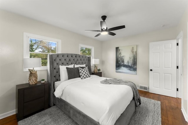 bedroom with ceiling fan and dark wood-type flooring