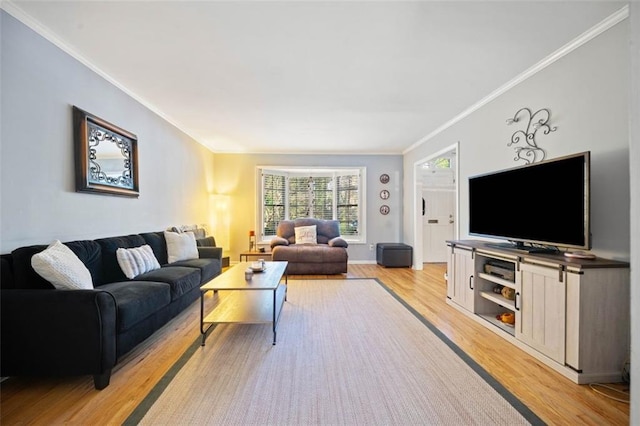 living area with ornamental molding and light wood finished floors