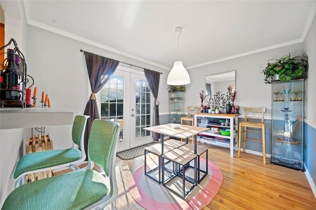 dining room featuring ornamental molding, french doors, baseboards, and wood finished floors