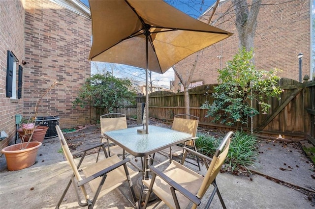 view of patio with outdoor dining area and a fenced backyard