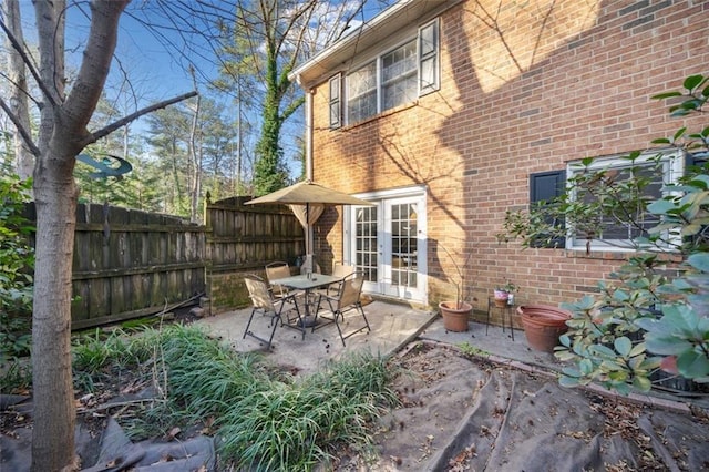 view of patio / terrace featuring fence and french doors