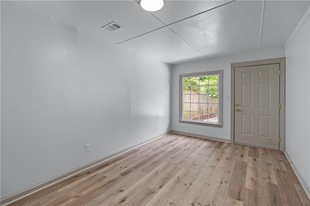 doorway with light wood finished floors and baseboards