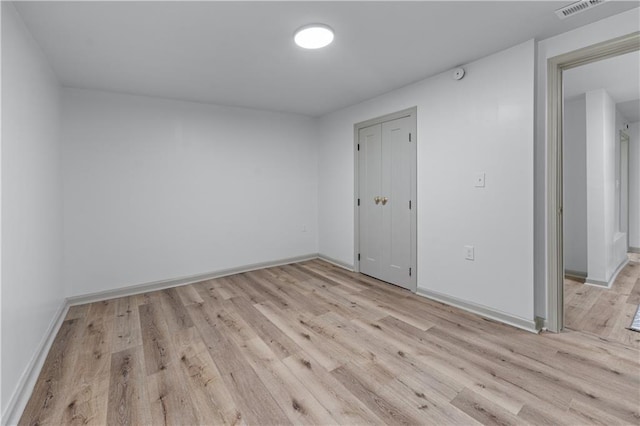 unfurnished room featuring light wood-style floors and baseboards