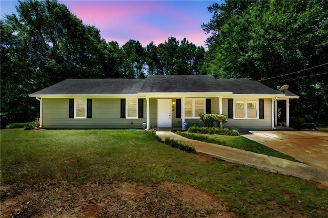 ranch-style home featuring a yard