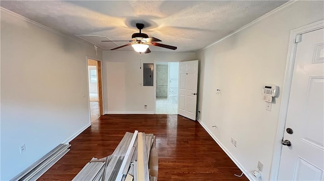 spare room featuring a textured ceiling, wood finished floors, electric panel, and baseboards