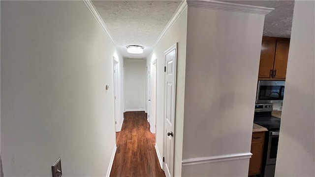 hallway featuring baseboards, ornamental molding, dark wood finished floors, and a textured ceiling